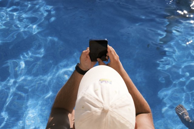 a photograph of a person is taking a picture of a person in a pool
