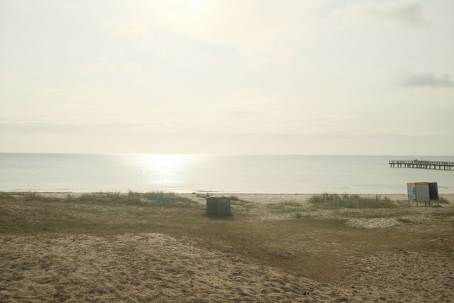 a photograph of a bench with a bench and a bench in the sand
