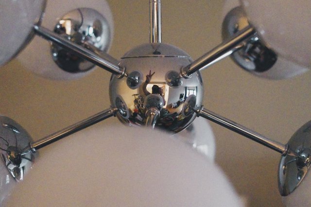 a photograph of a chandelier with a chrome ball and chrome balls