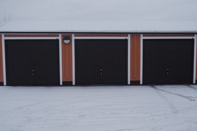 a photograph of a garage with a garage door and a fire hydrant