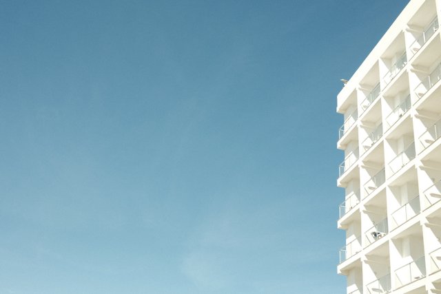 a photograph of a person standing in front of a tall building